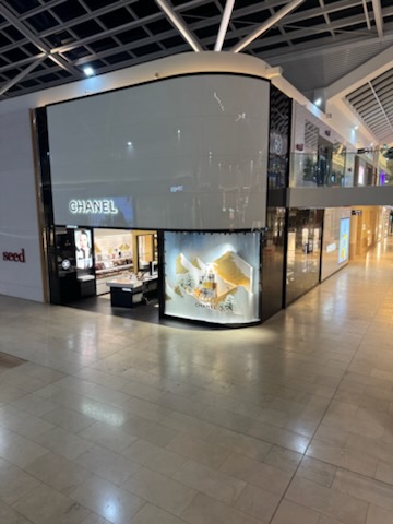 Completed Chanel Burnside shopfront with curved white cladding and black stone framing