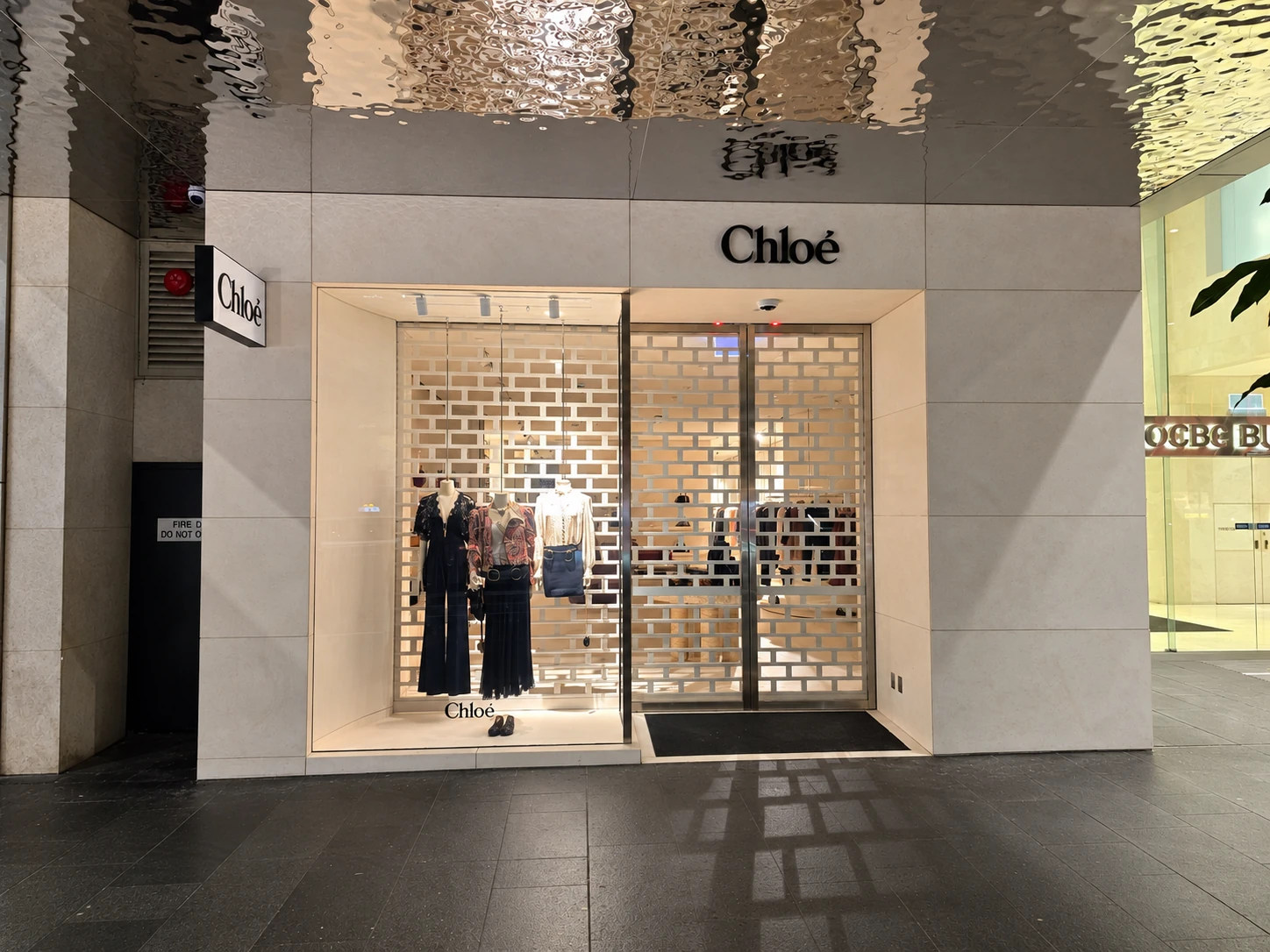 Chloé shopfront with pale stone cladding, mitred corners and illuminated signage